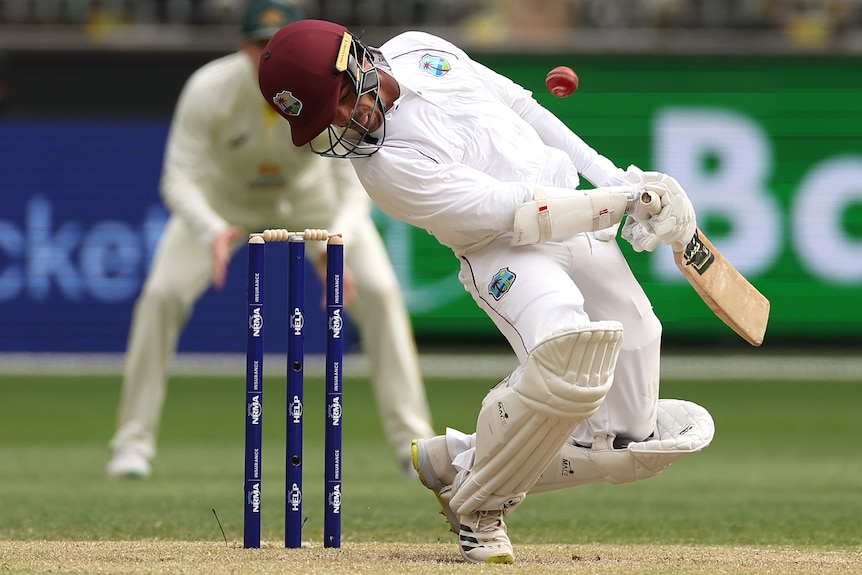 West Indies batter Tagenarine Chanderpaul dodges a cricket ball bowled by Australia in a Test at Perth Stadium.