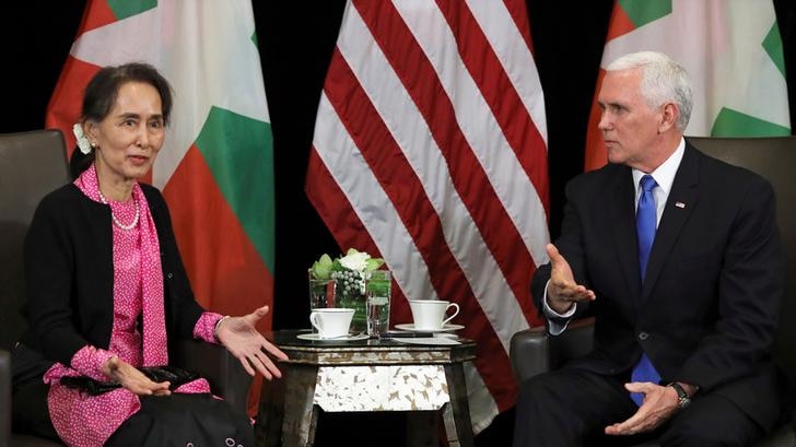 Myanmar's State Counsellor Aung San Suu Kyi gestures in frustrated manner at meeting at table with US Vice President Mike Pence