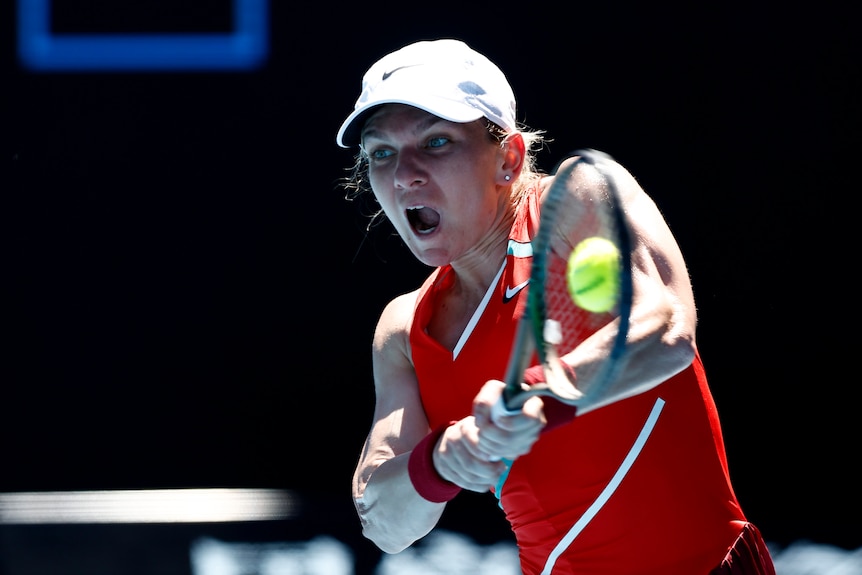 A Romanian female tennis player hits a backhand return at Australian Open.