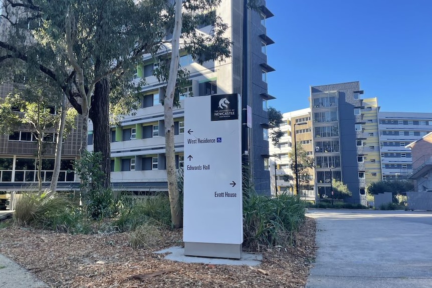 University of Newcastle buildings and a sign pointing to student residence.