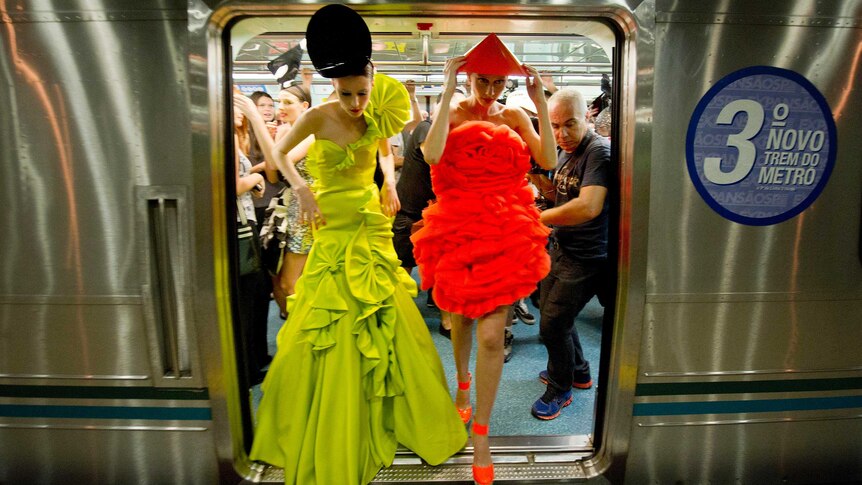 Models step from a train in Sao Paulo's subway on the eve of the 2013 Winter Sao Paulo Fashion Week.