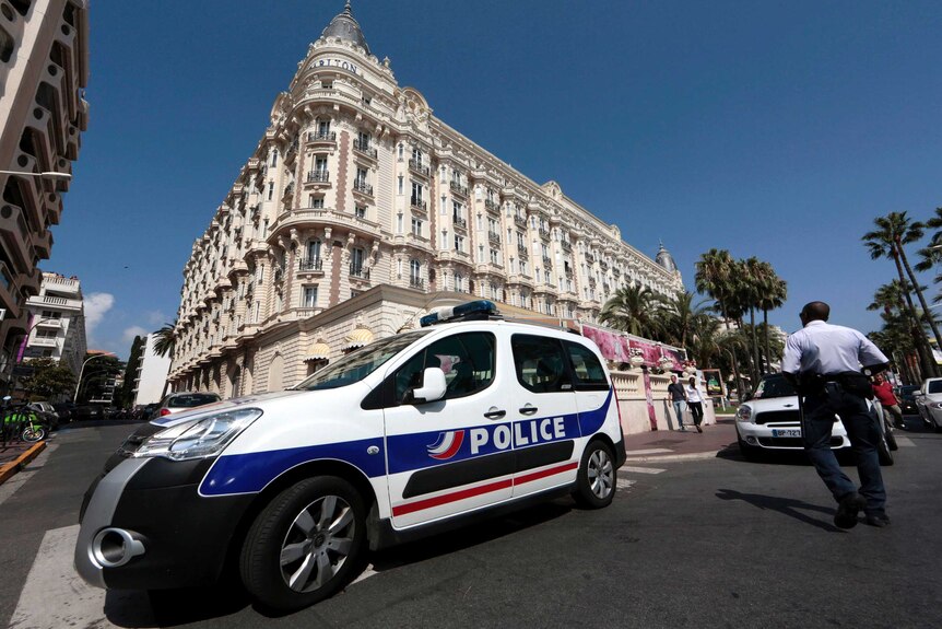 Police car parked outside the Carlton hotel in Cannes after a robbery at the hotel.