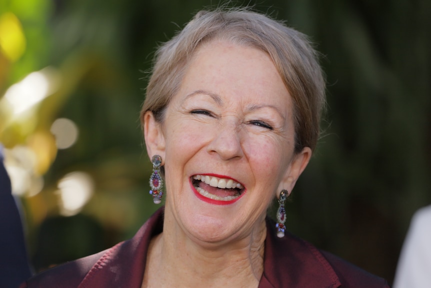 A close-up of Queensland minister Di Farmer with red lipstick laughing