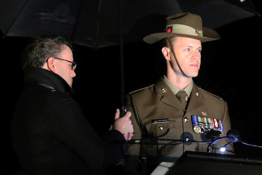 Curtis McGrath speaks at a lectern.