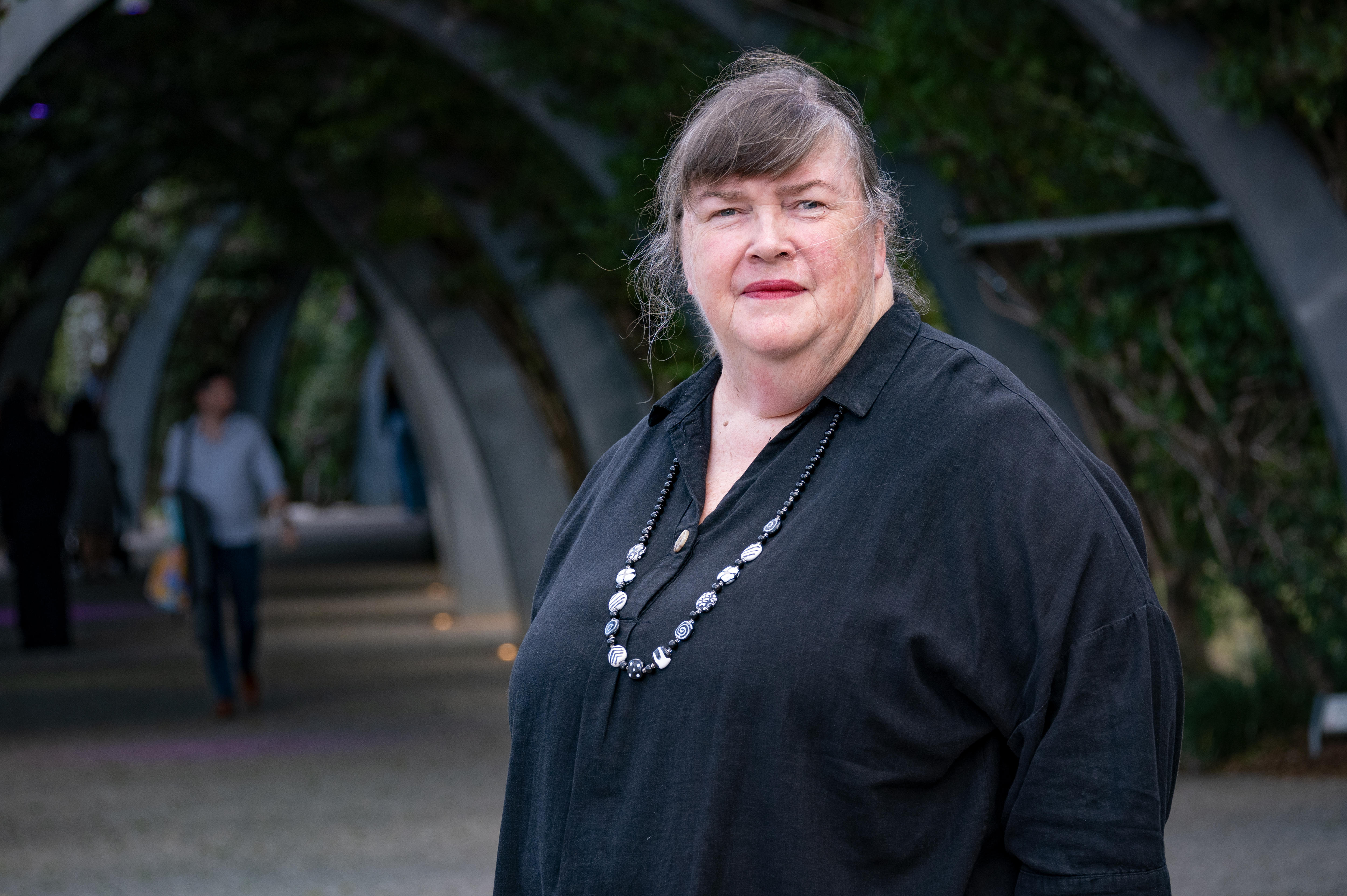A stern woman in an archway