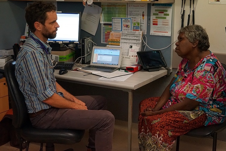 Dr Simon Quilty consults with a patient in his office.