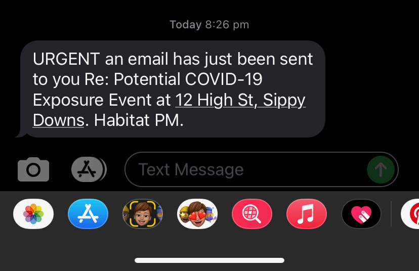 A screenshot of a text message about potential COVID-19 exposure in a Queensland apartment building.