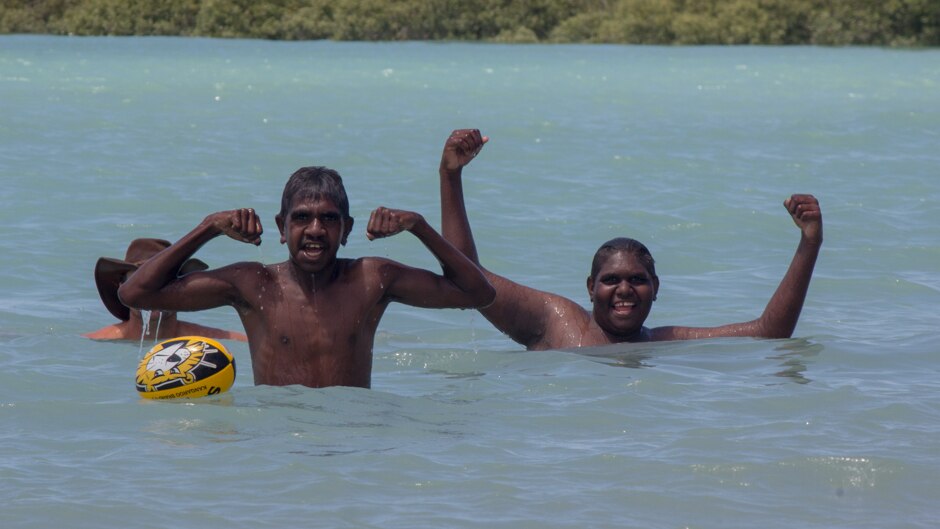 Two teenage boys from the desert community of Balgo Hills swim at Broome's Town Beach.