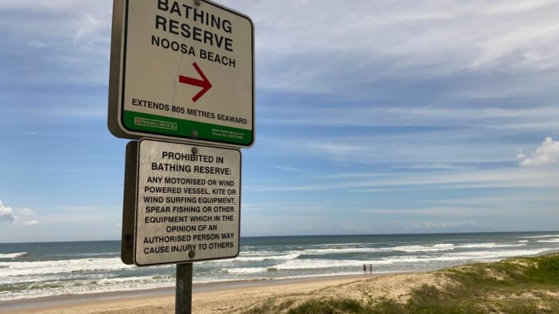 A beach with sign in front