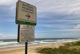 A beach with sign in front