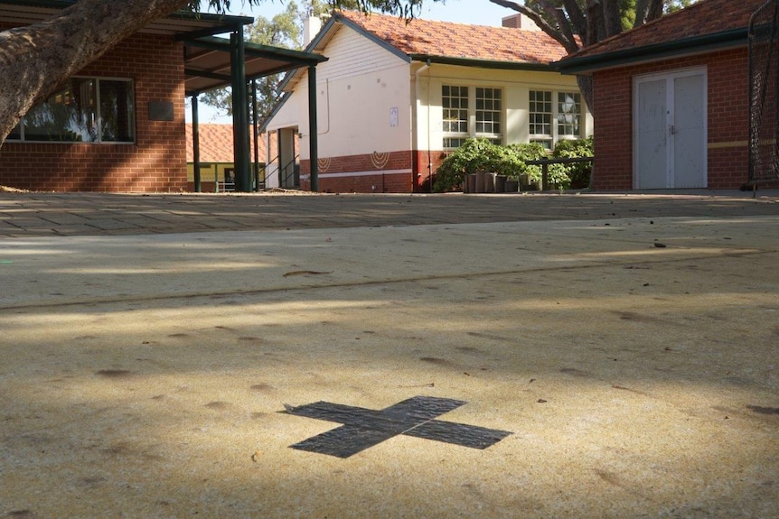 A black cross is marked on the footpath outside Wembley Primary School.