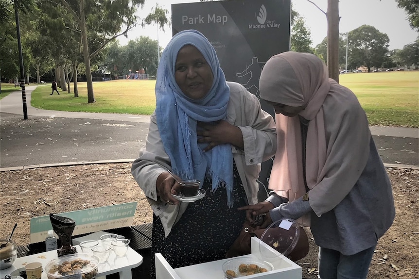 Nagat Abdalla cooking food in park.