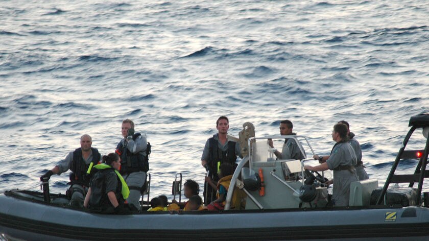 Seeking asylum: Navy personnel with the rescued boat passengers