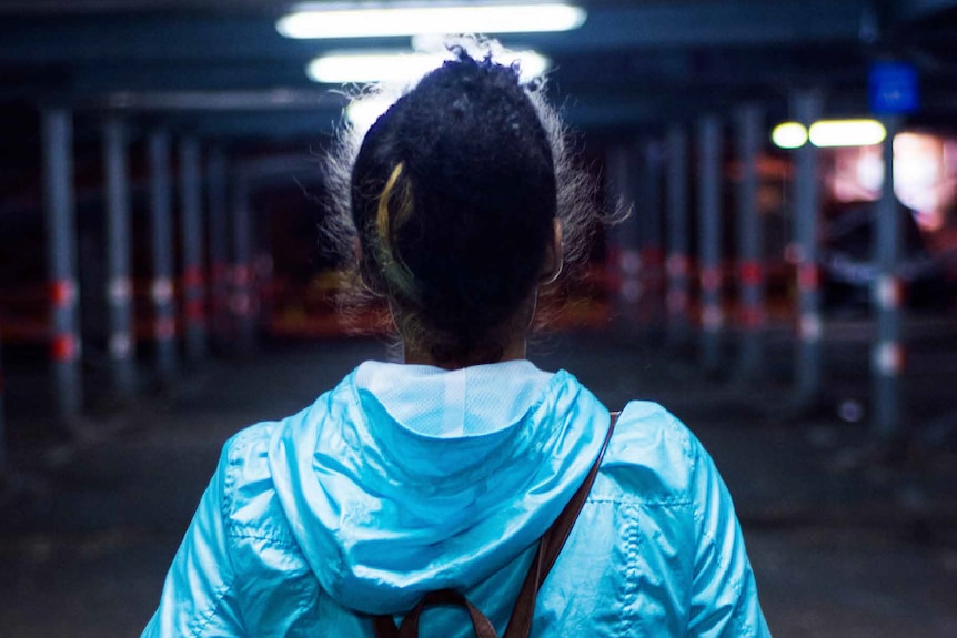 A woman walking at night