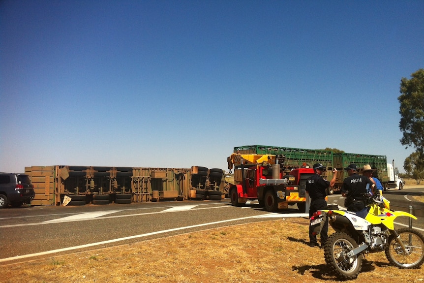 Crane clears road train trailer