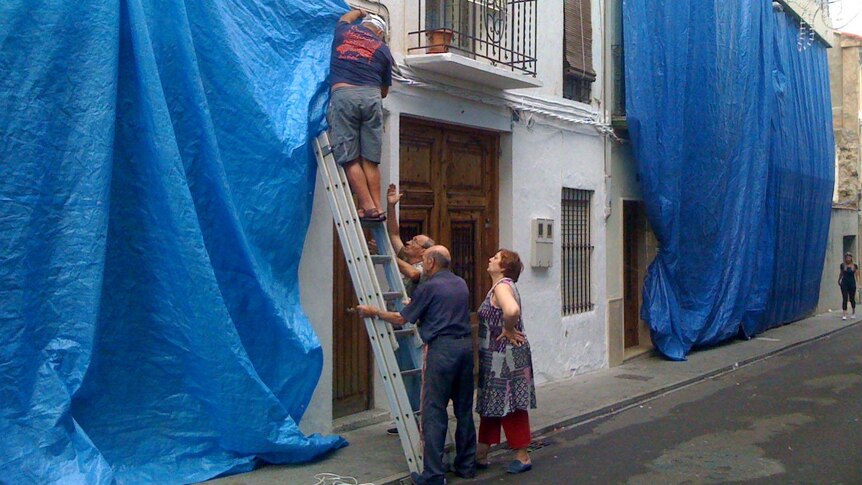 Residents of Bunol cover their house ahead of the Tomatina festival.