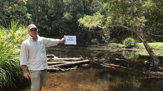 Brad Wedlock holding up a folder at one of the test sites