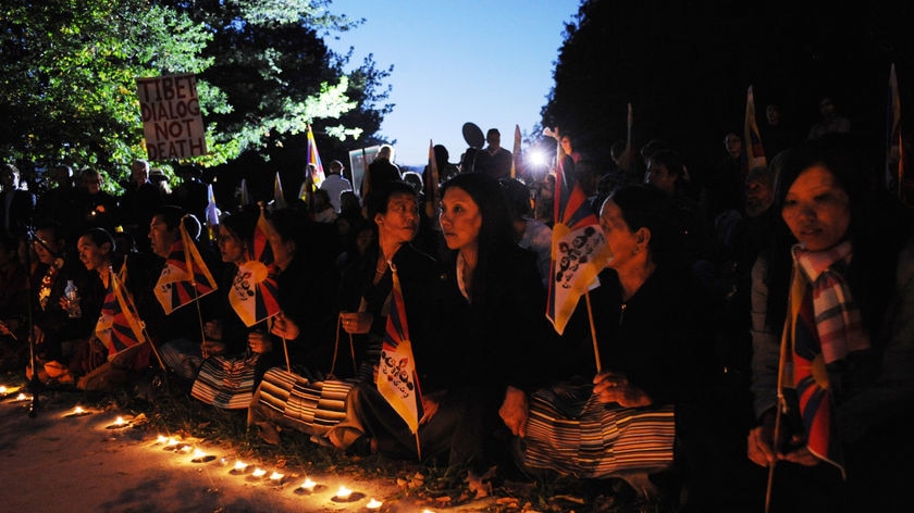 The demonstrators have lit several hundred candles, some spelling out the phrase 'Free Tibet'.