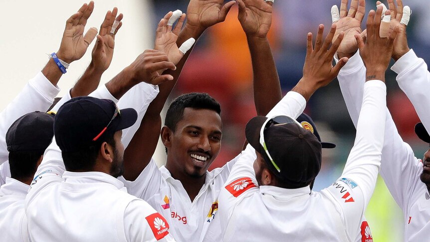 Vishwa Fernando hi-fives with team-mates after taking a wicket for Sri Lanka in Canberra