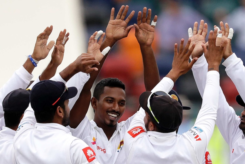 Vishwa Fernando hi-fives with team-mates after taking a wicket for Sri Lanka in Canberra