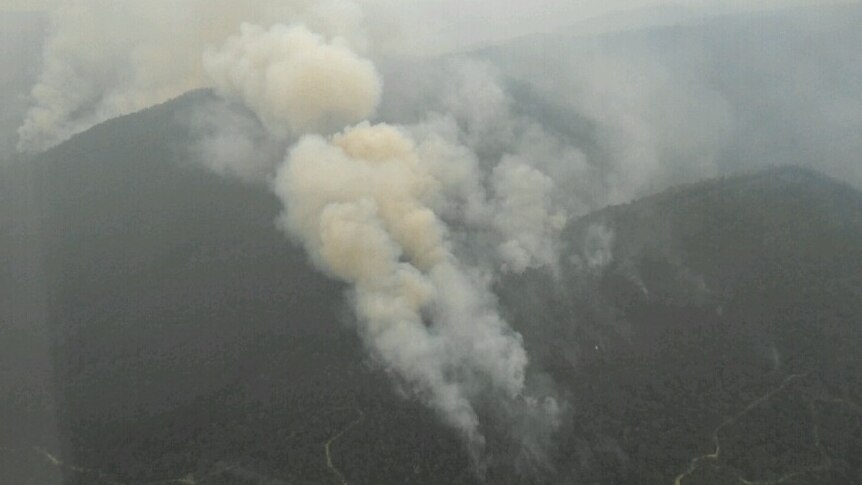 The view of a smoky fire from out of a plane.