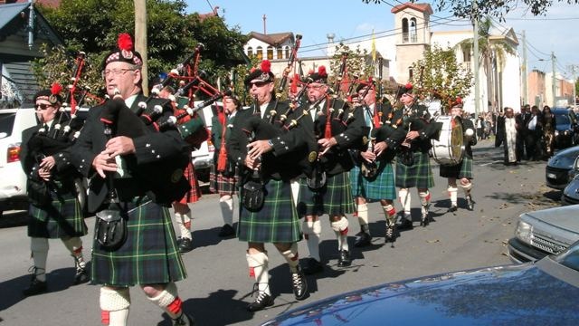 The City of Newcastle RSL Pipe Band leads the Margaret Goumas funeral procession in Hamilton