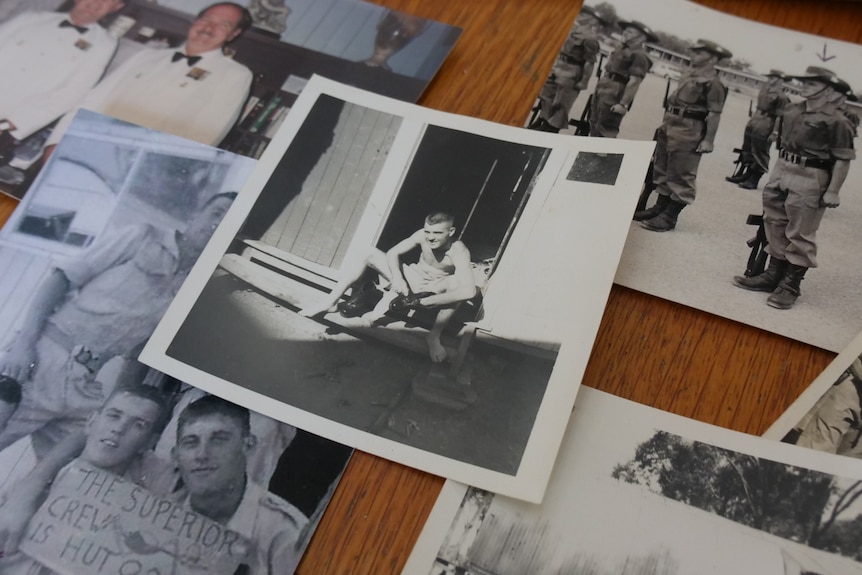 Old photos on a kitchen table that show a young man in the Australian Army in the 1960s.
