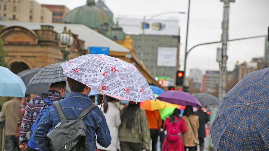 People walking under umbrellas in Melbourne.