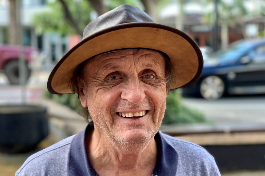 A man in a leather hat smiling