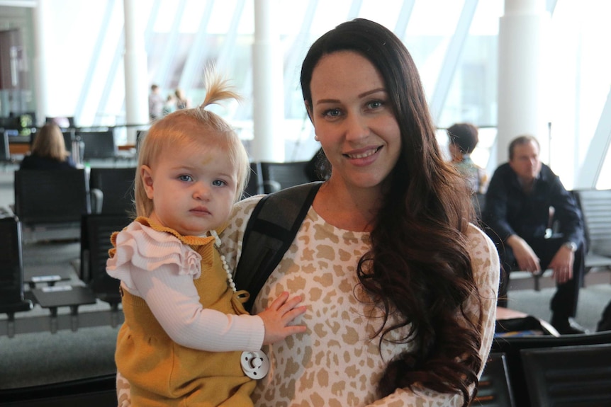 A mum and baby at the airport