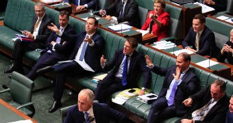 One woman, wearing a red jacket, is visible amongst her male Liberal colleagues.