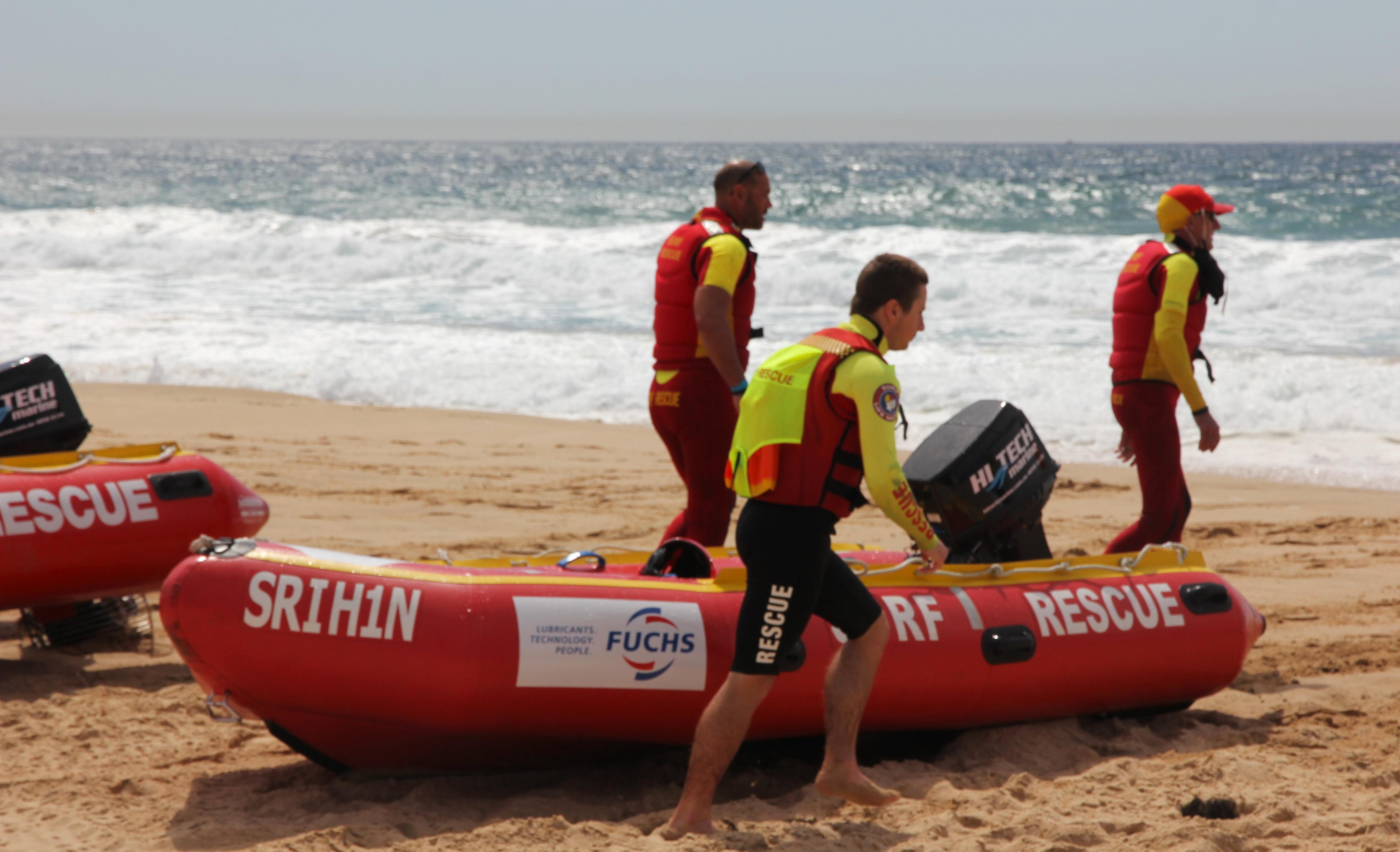 image of life savers on beach sand 