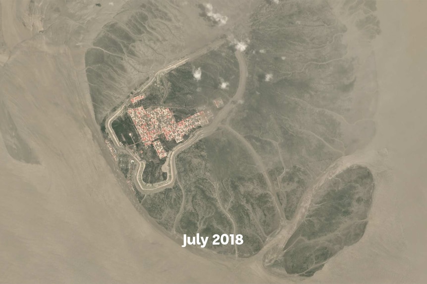 A satellite image showing roads and red roofs of houses appearing on a small island