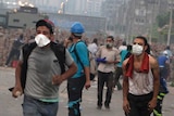 Morsi supporters in Cairo run from tear gas thrown by police