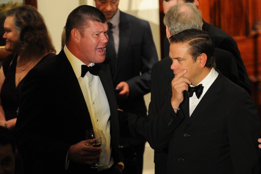 James Packer and Lachlan Murdoch both in tuxedos with black bow ties, Murdoch with a hand to his chin