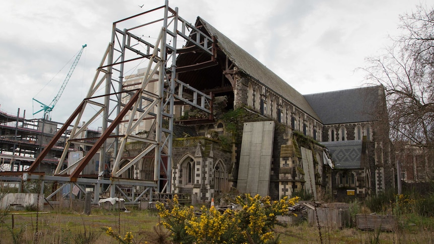 The remains of the iconic Christchurch Cathedral. Half of the front wall is still missing, and it is supported by scaffolding.