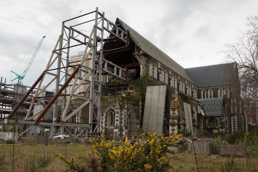 The remains of the iconic Christchurch Cathedral. Half of the front wall is still missing, and it is supported by scaffolding.