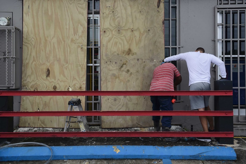 People board up windows in preparation for Hurricane Irma.