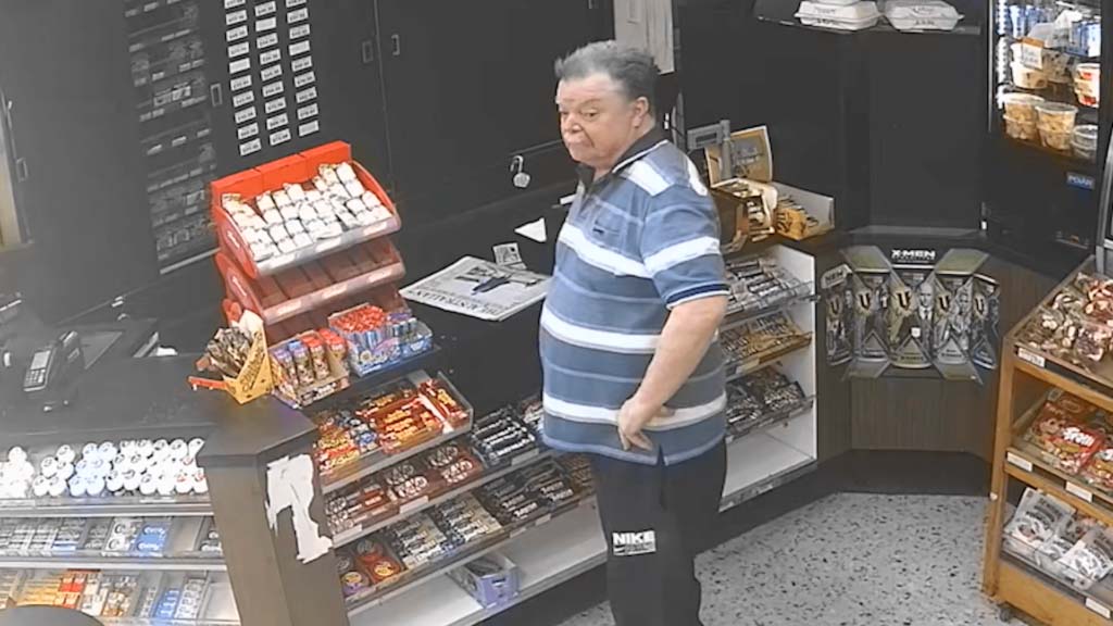 A man stands in a grocery shop.