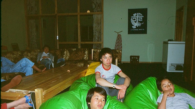 Phuoc Vo watches television on a bean bag.