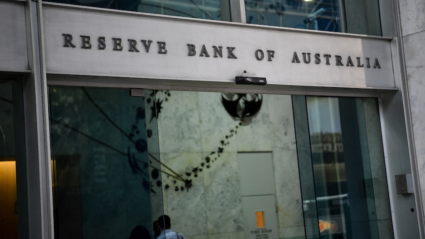 Sliding glass doors into a building with the words Reserve Bank of Australia written above.