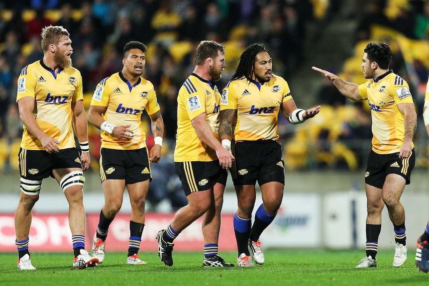 Ma'a Nonu of the Hurricanes is congratulated on his try by Hurricanes team-mates against the Chiefs.