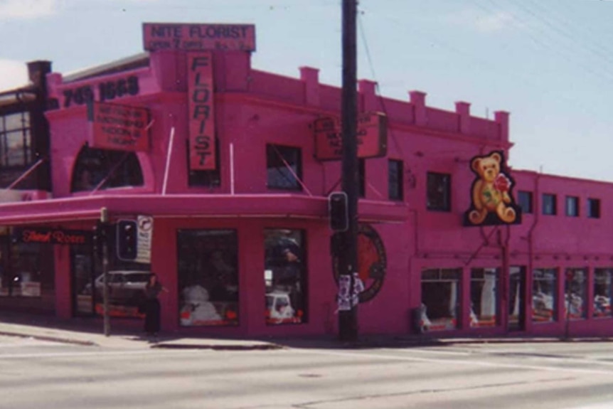 A historical photo shows a pink corner building