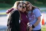 Emma, Cheryl and Sophia Rothenberg embrace at the memorial marking one year since the Parkland, Florida shooting