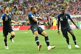 Kylian Mbappe crosses arms to celebrate scoring in World Cup final