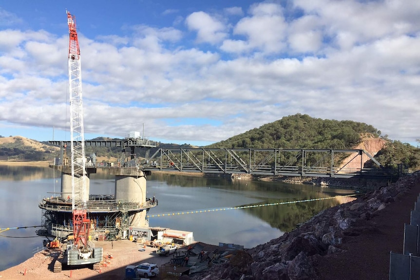 A crane works on the cement water outlet structure as part of the Chaffey Dam upgrade, near Tamworth.
