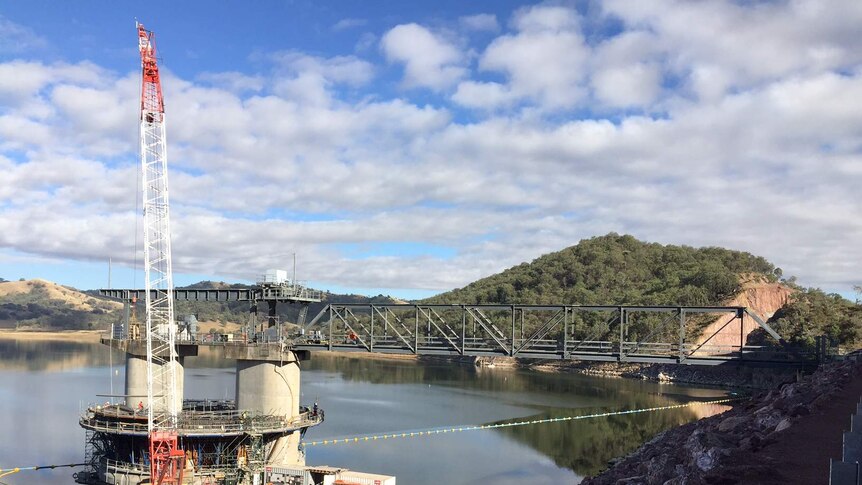A crane works on the cement water outlet structure as part of the Chaffey Dam upgrade, near Tamworth.