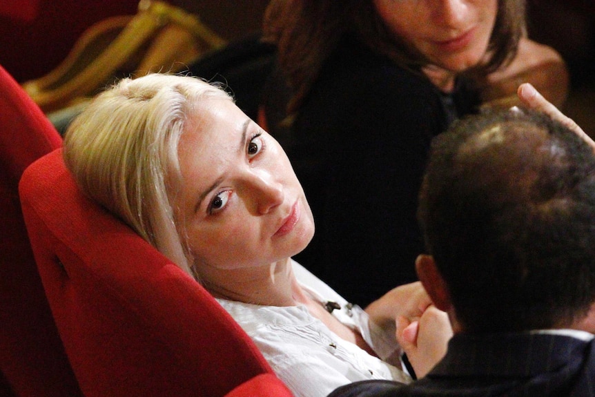 Domnica Cemortan looks at a photographer during the trial of Francesco Schettino.
