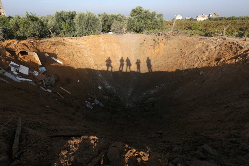 The crater left by an Israeli retaliatory air strike that demolished the house of a Palestinian family.