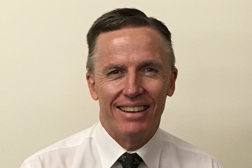 Man smiling for camera in business suit  